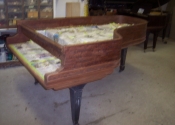 Rim of piano stripped and being prepared for refinishing.