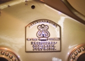 Hand stenciled Steinway logo on plate.